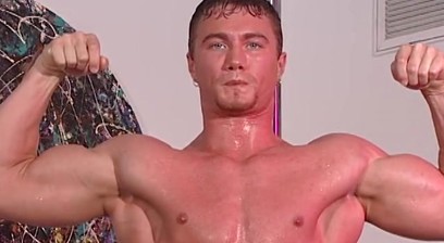 Wet Bodybuilder Poses with a Hard On on a Stripper Pole